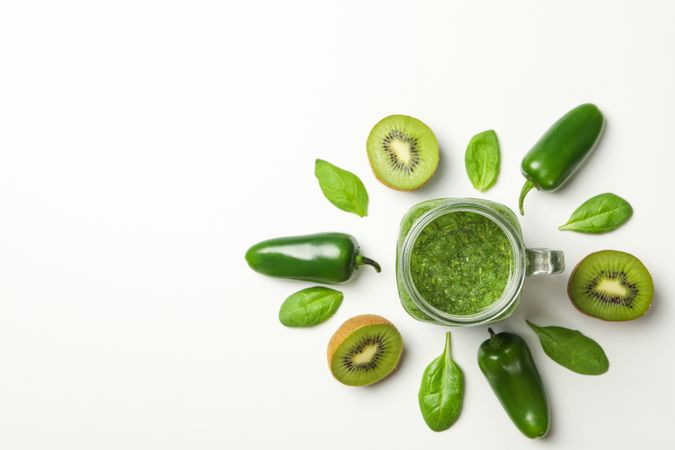 Kiwi, spinach, pepper and smoothie on blank background