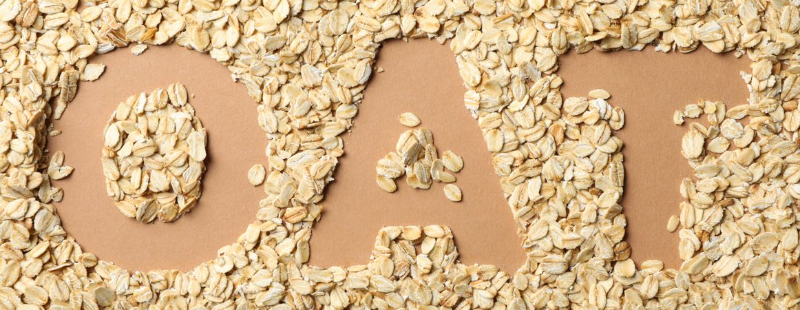 Text Oat made of oatmeal flakes. Oatmeal background