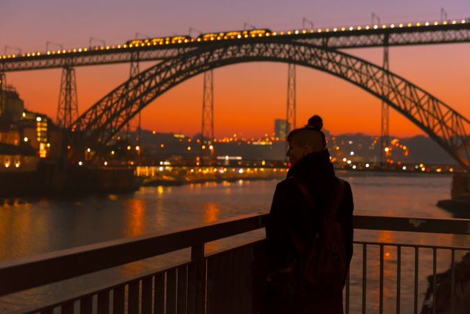 Female walking on embankment during sundown