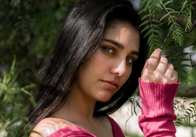 Young charming woman between flowers