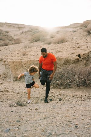 Black father preparing for sport training with child