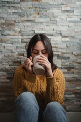Woman drinking hot tea at home