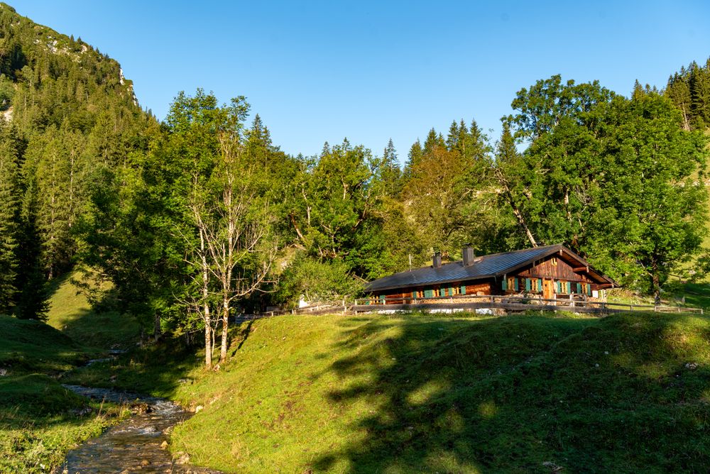 Alpine scenery with a log cabin in the Bavarian Alps, on a sunny day in summer