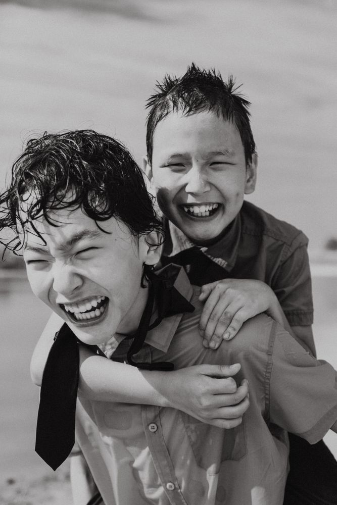 Happy boy in piggyback ride over back of brother