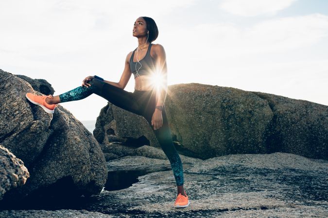 Fitness woman training outdoors on rocks