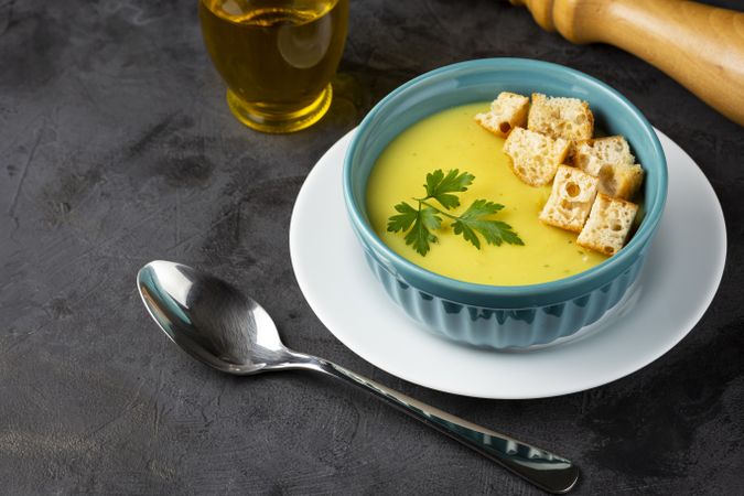 Bowl with onion soup and croutons on the table.