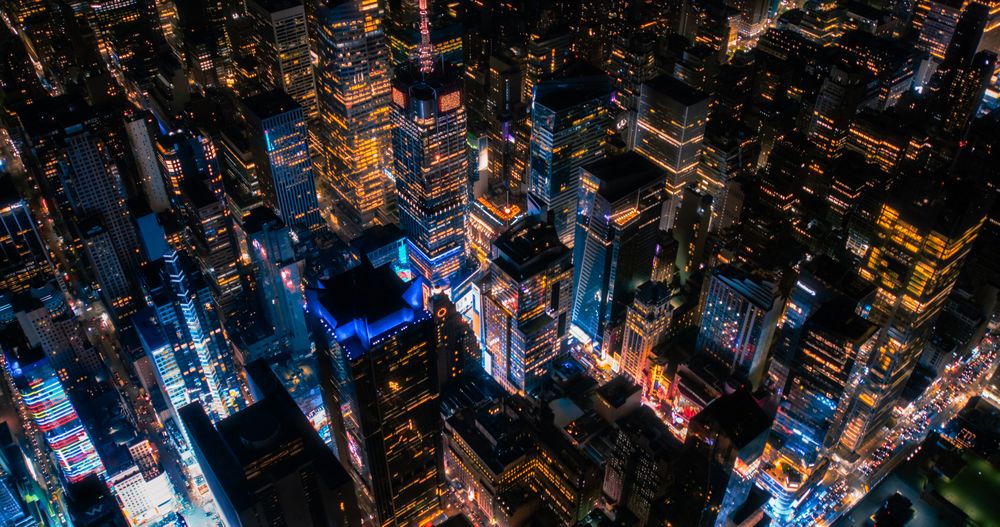 Helicopter Night Tour of New York City Architecture. Glowing Times Square with Groups of Tourists Enjoying Manhattan Nightlife and Admiring the Landmark with Diverse Advertising Billboards