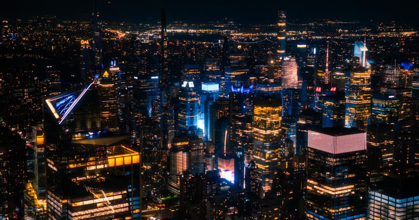 Aerial View of Manhattan Architecture at Night. Evening Photo of Financial Business District from a Helicopter. Scenery of Historic Office Towers, Illuminated Skyscrapers