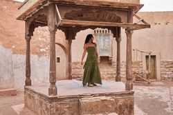 Woman dancing on street stage between ancient buildings