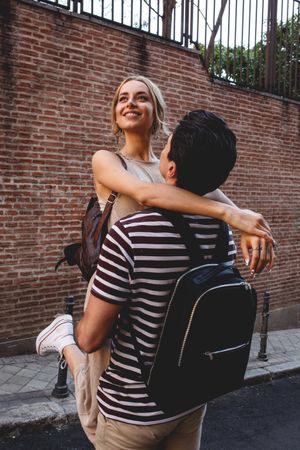 Happy couple having fun while walking in town