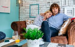 Couple hugging on a sofa