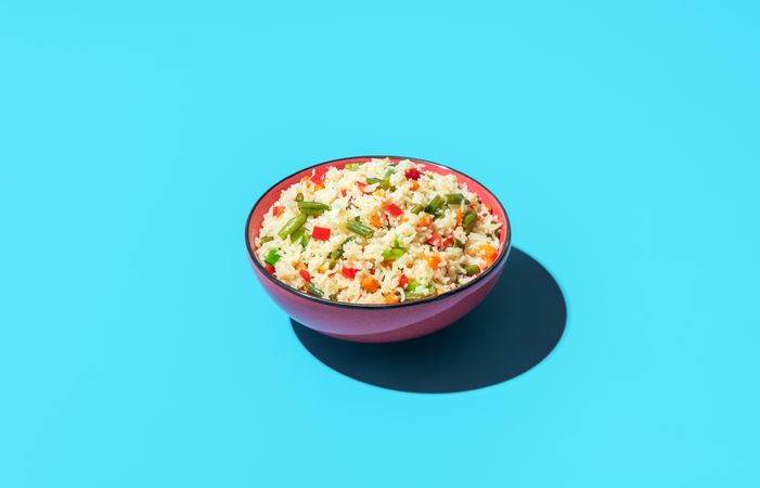 Fried rice dish isolated on a blue background