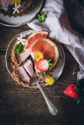 Strawberry and citrus cake served on wooden table