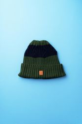 Green beanie on blue background