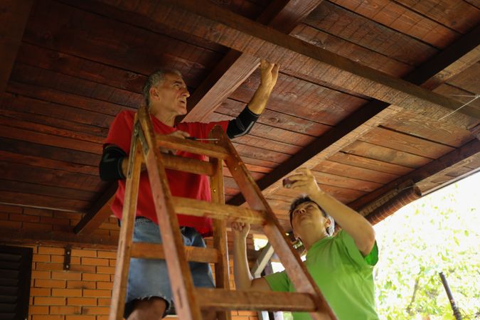 Older couple inspecting their roof.
