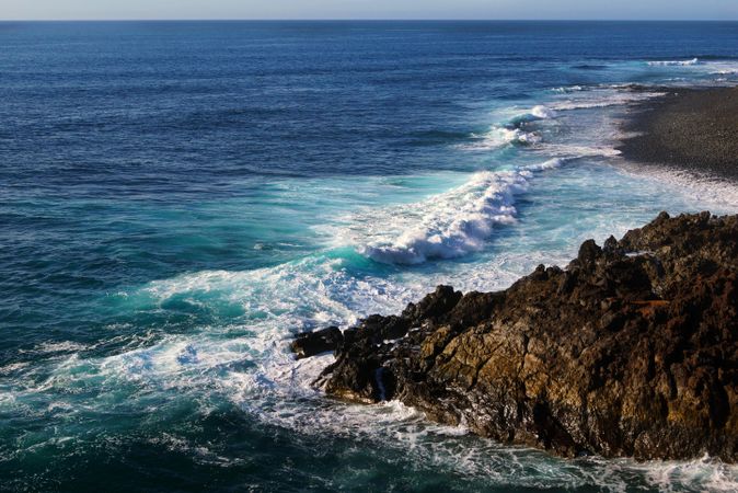 Beautiful and picturesque view of surface of sea water among high rocky cliffs on sunny day