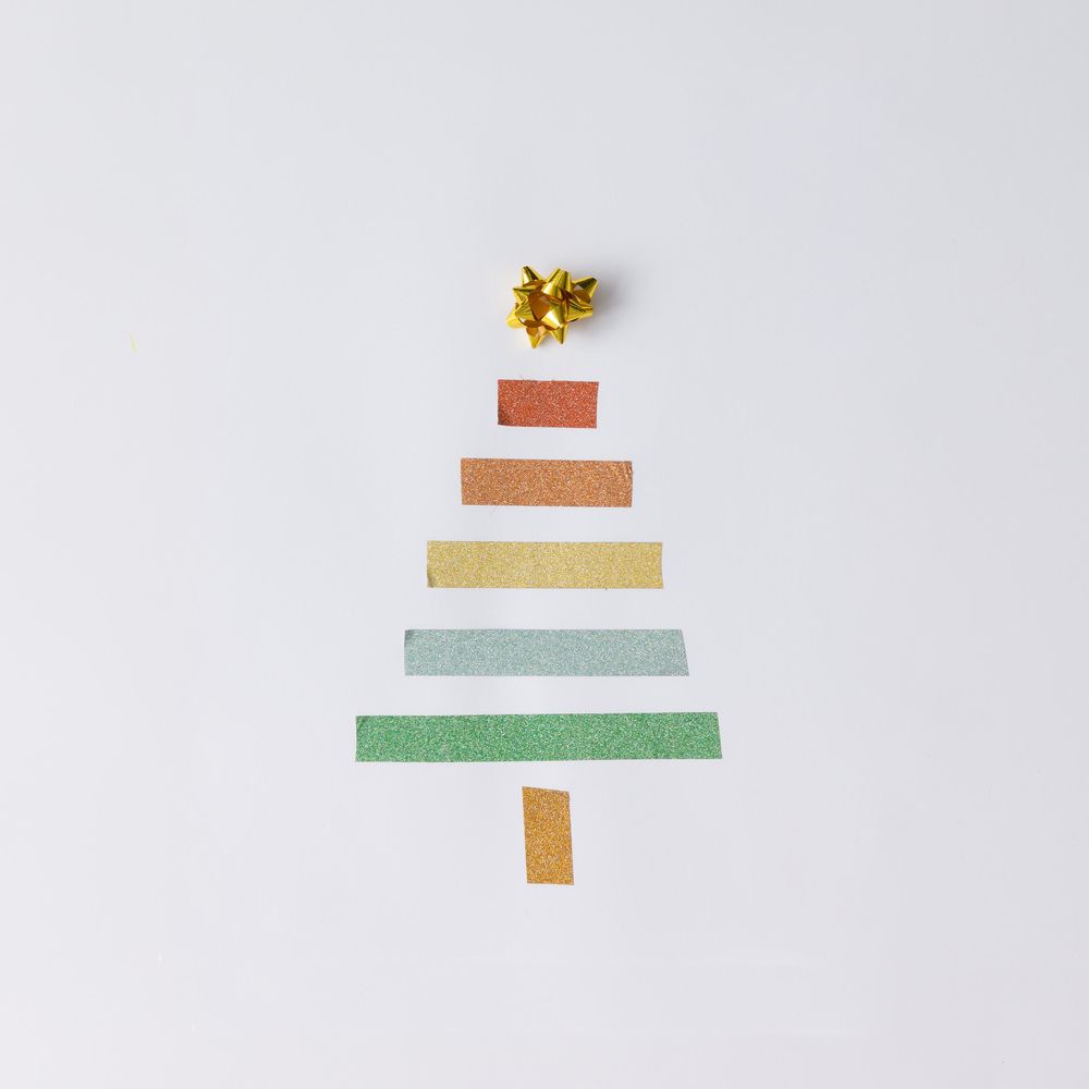 Minimalistic Christmas tree made of tape on light background