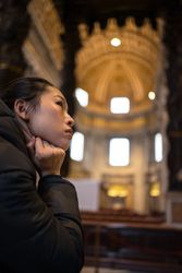 Curious Asian female on vacation sightseeing in beautiful temple