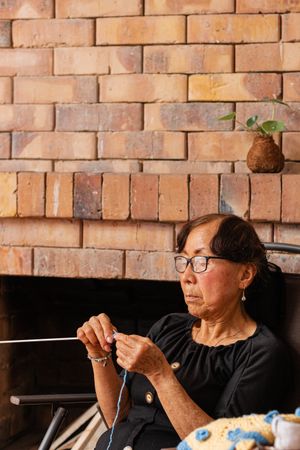 Thread of joy. Mature female knits her life's story.
