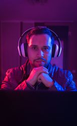 Man listening cheerfully to music with headphones.