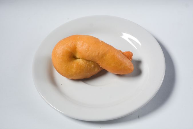 Collection of donuts on ceramic plate, isolated objects