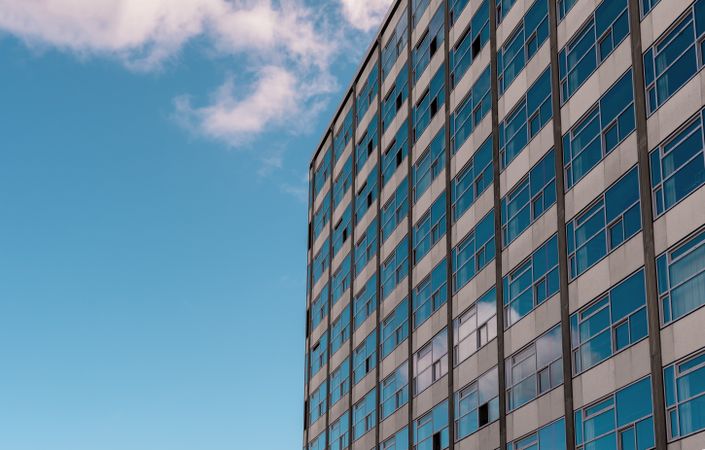 Office building facade under blue sky, on a sunny day