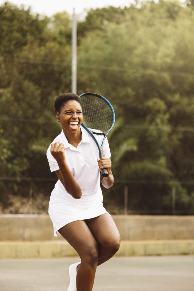 Woman celebrating a point during a tennis match
