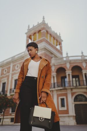 Stylish Black woman with handbag on street
