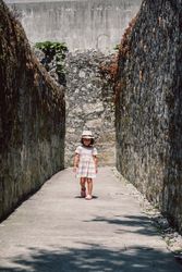 Girl in narrow stone walkway