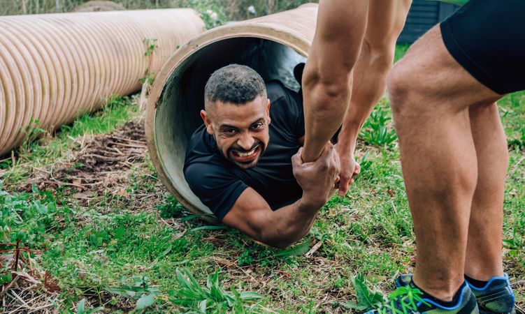 Participants obstacle course going through a pipe