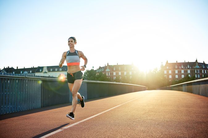 Smiling woman running during the morning