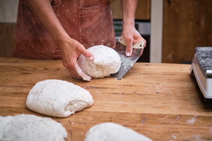 Photo detail of a baker's hands working the bread dough