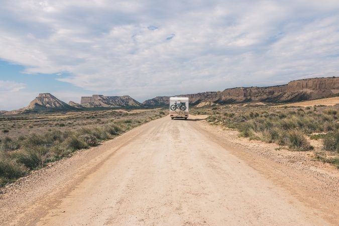 trailer on empty road along desert