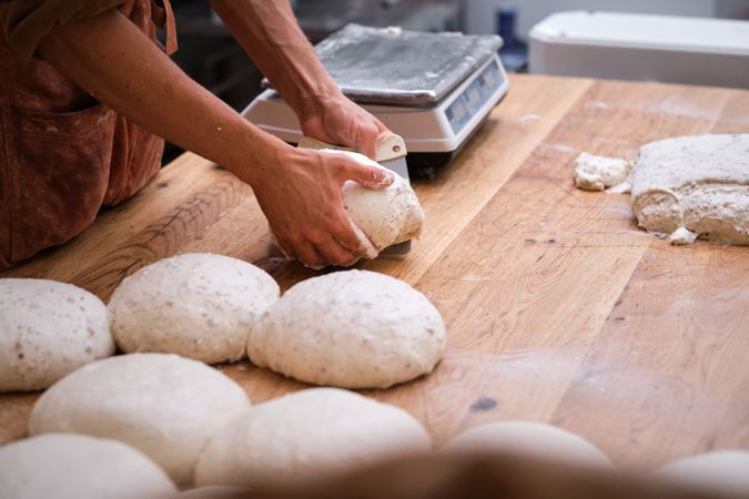 Photo detail of a baker's hands working the bread dough