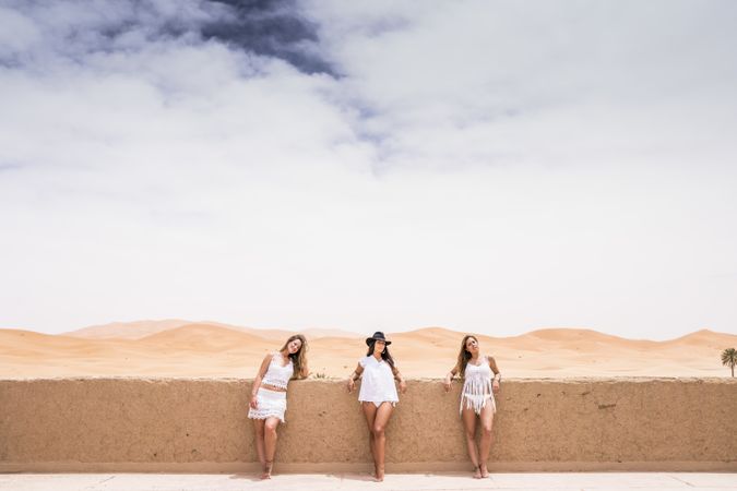 Women in white on desert landscape