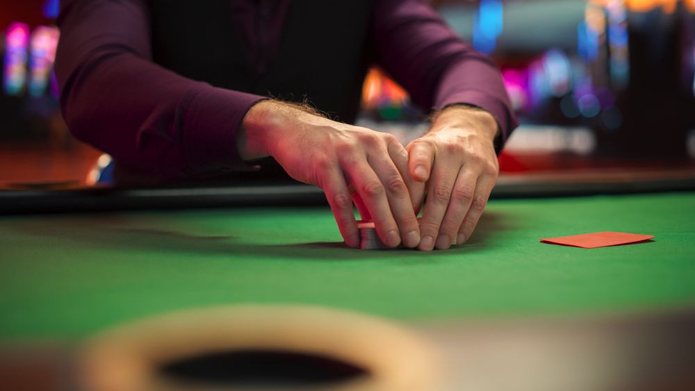 Anonymous Croupier Shuffling Deck Before Competitive Tournament.