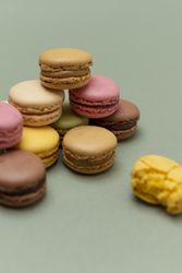 Delicate tasty macaroons over a green background
