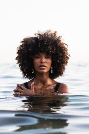 Black woman in bikini in sea