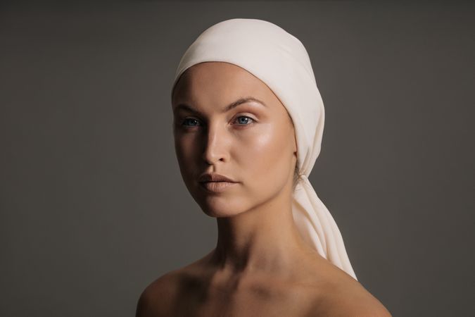 White woman with a scarf wrapped on her head