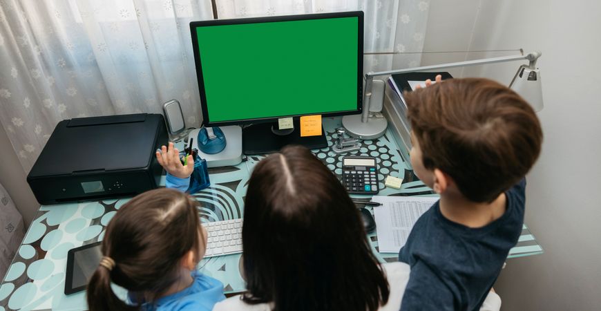 Mother and children looking at computer screen