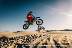 Dirt bikers riding mid air in desert 48OvJ5