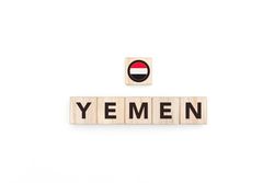 Wooden blocks bearing the name and flag of Yemen.