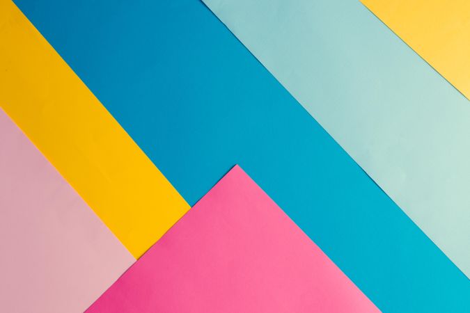 Colorful bright geometric pattern of yellow, blue, and pink paper