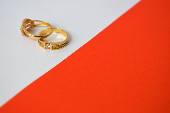 Two diamond gold rings on duotone background