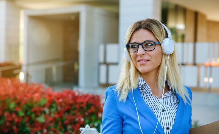 Businesswoman with headphones and mobile