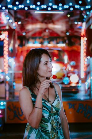 Woman with lollipop in amusement park