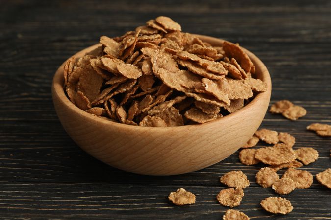 Bowl of tasty muesli on wooden background