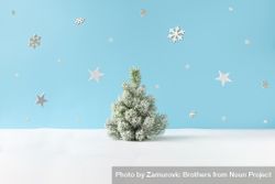 Snowy Christmas tree on blue background, with snowflakes bEW875