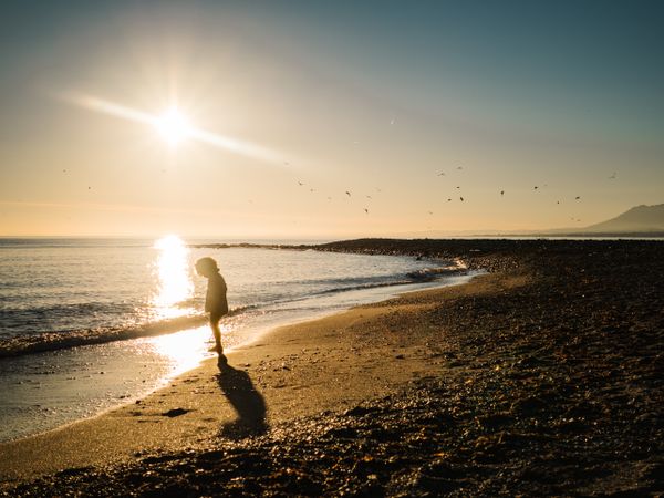 small girl walking by the beach
