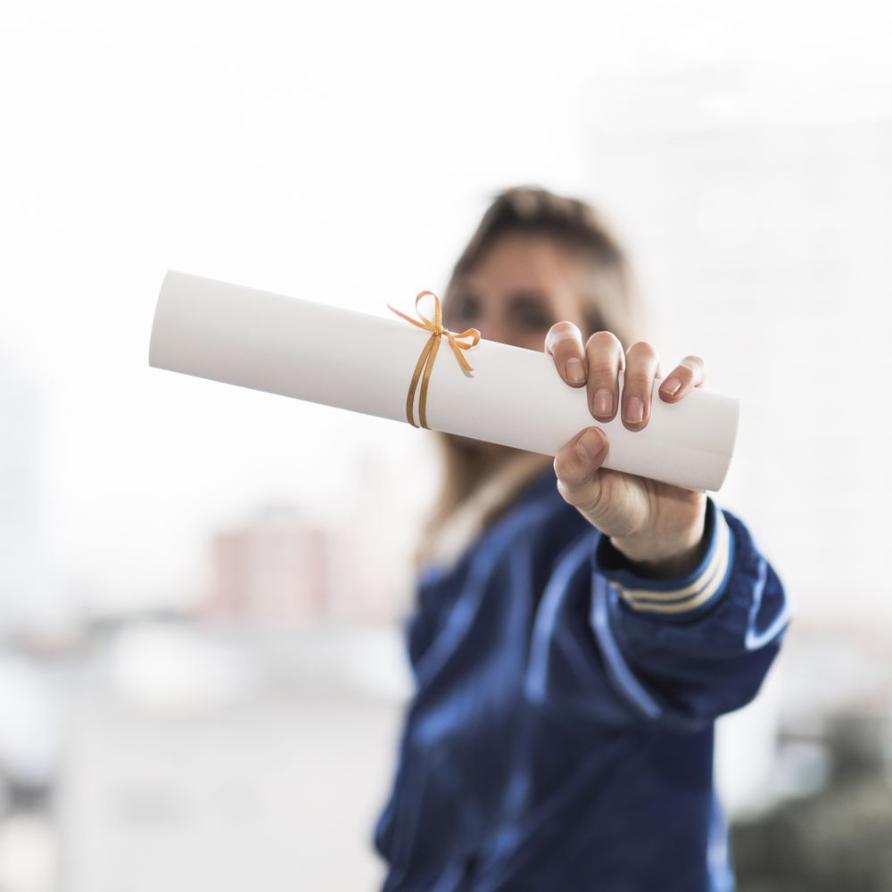 Woman holding out diploma